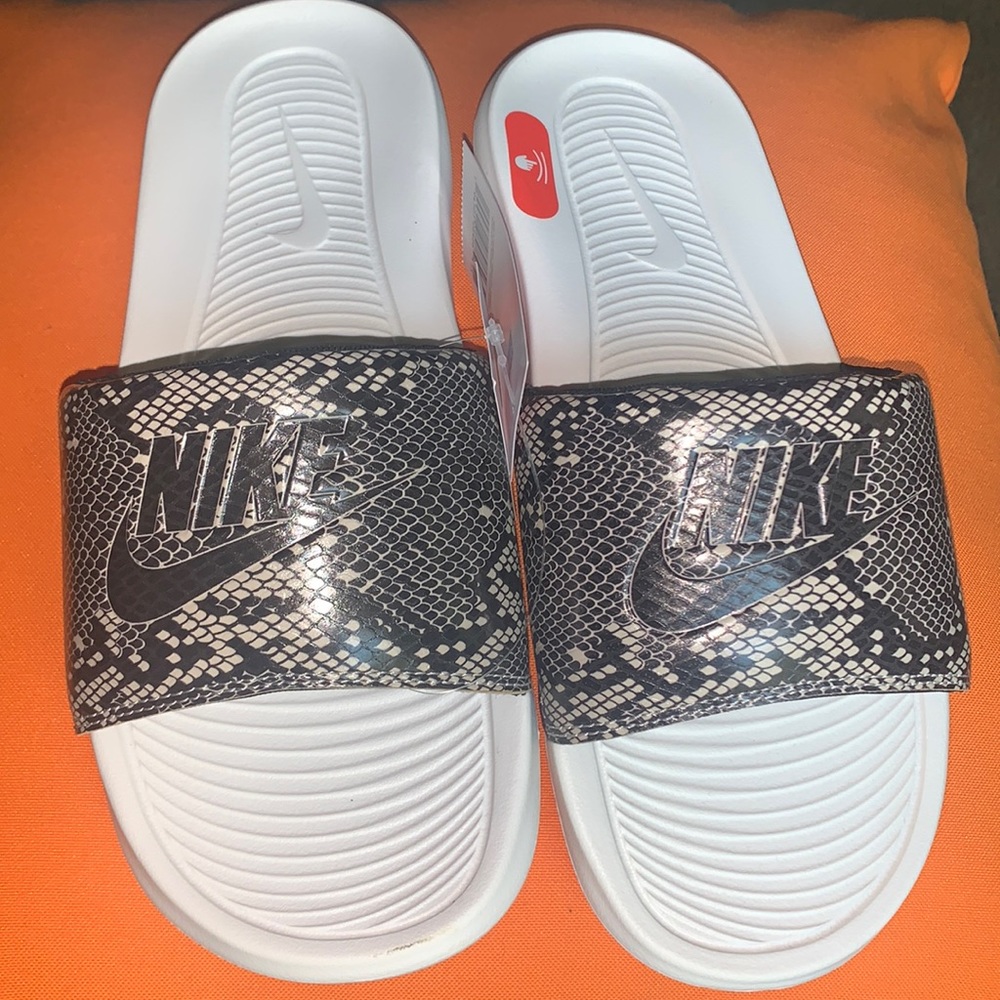 Nike, women’s slide, size 9, with sleek, black and beige snake print.